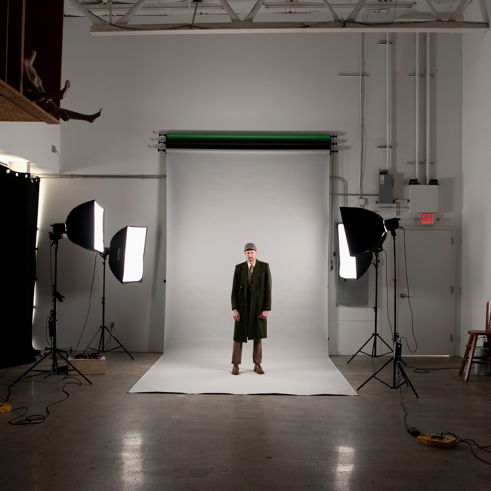 A model lit by two softboxes on white seamless paper inside the Arabi Visual Arts studio